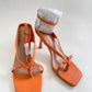 Orange strappy heels